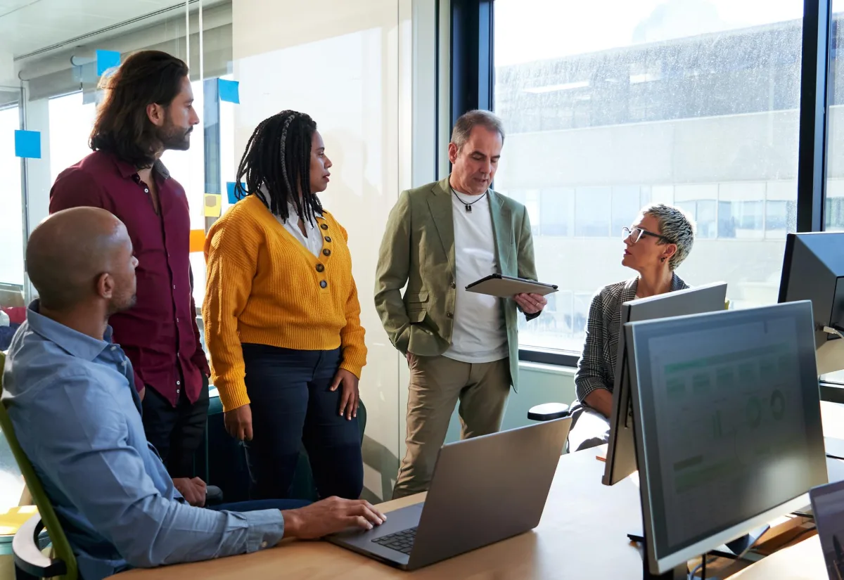 Diverse technology team collaborating on a project in a meeting