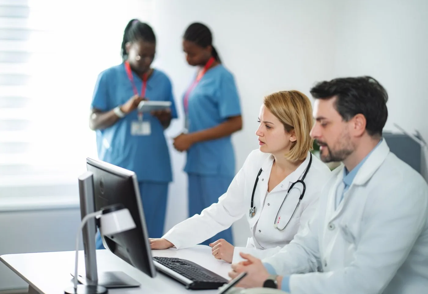 Healthcare technology professionals collaborating on systems in a modern facility